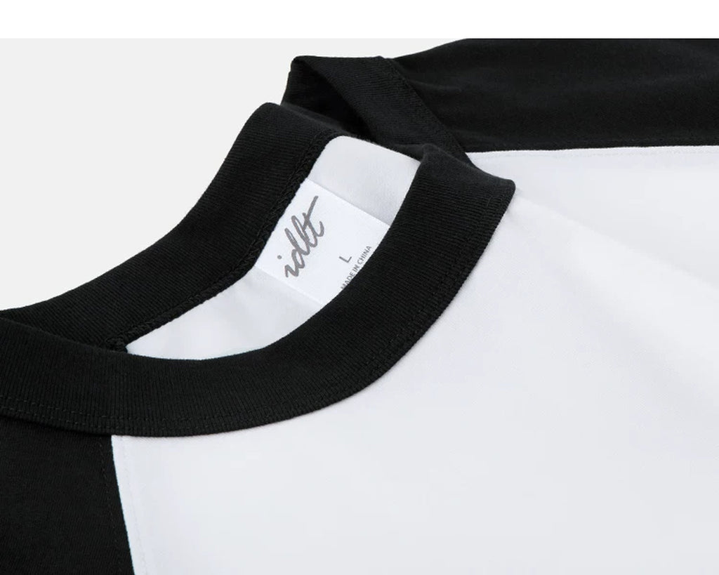 IDLT raglan T-shirt, black and white neckline stitching.