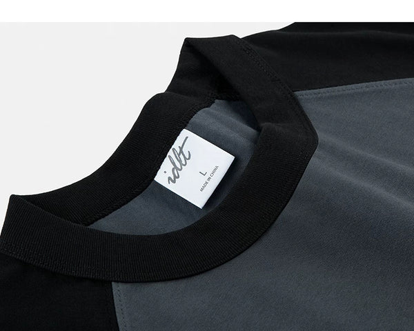 IDLT raglan T-shirt, black and dark gray neckline stitching.