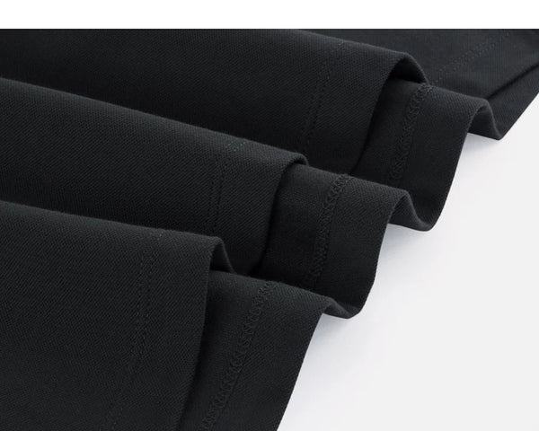 IDLT polo shirt, black hem stitching close-up.