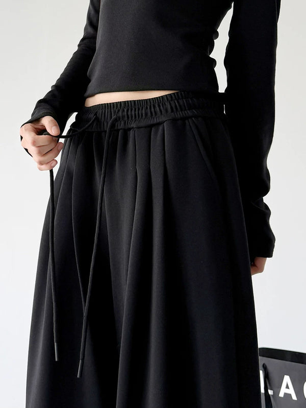 Black waist detail view of wide-leg pants