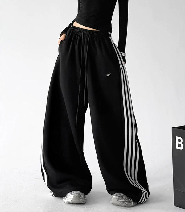 Black side-stripe wide-leg pants angled front - CT260