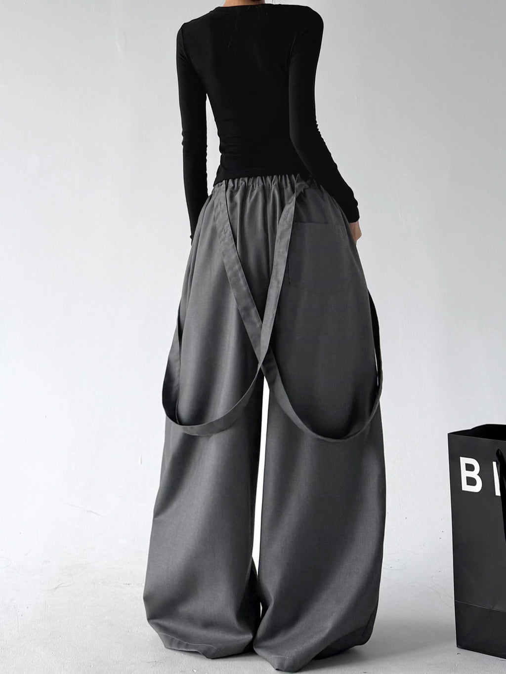Gray strap detail wide leg pants, back view