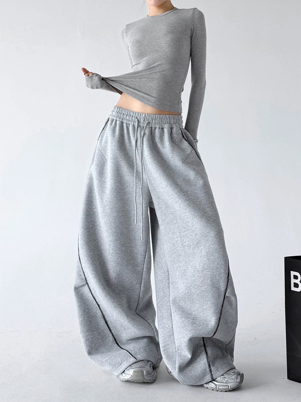 Gray wide-leg pants, front styling view.