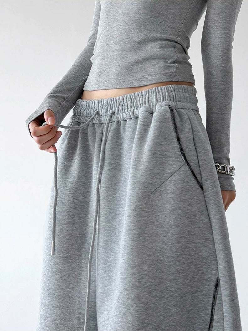 Gray curved-seam wide-leg drawstring pants, waist detail view.