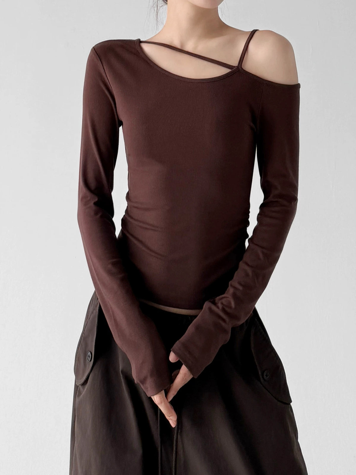 Brown long-sleeve top, front hands view