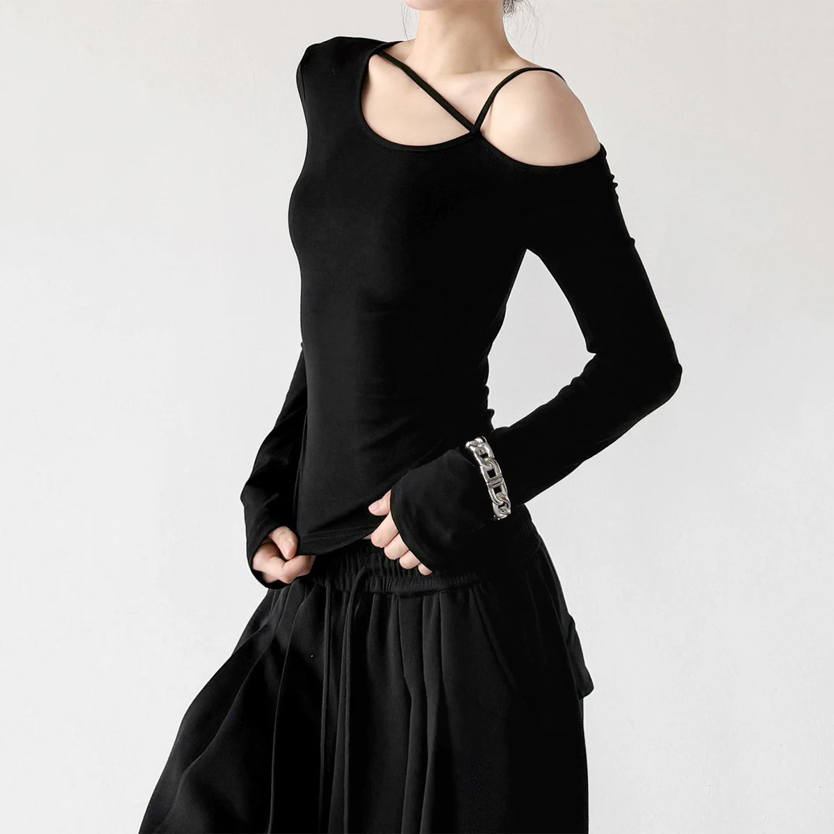 Black cross strap asymmetric top, angled front view