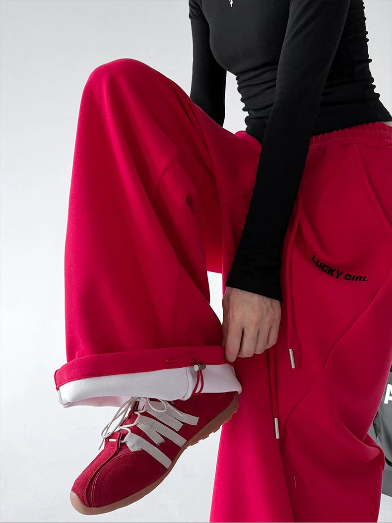 Red cuff detail view of wide-leg pants