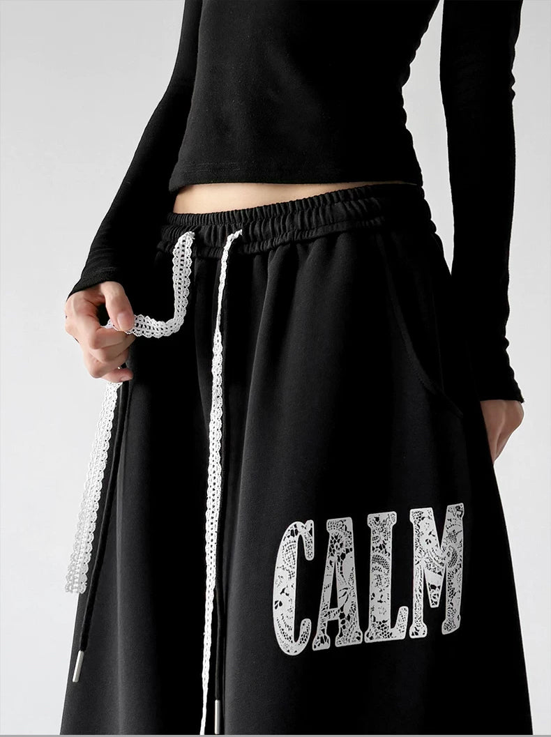 Black collegiate letter wide leg sweatpants, waist detail view