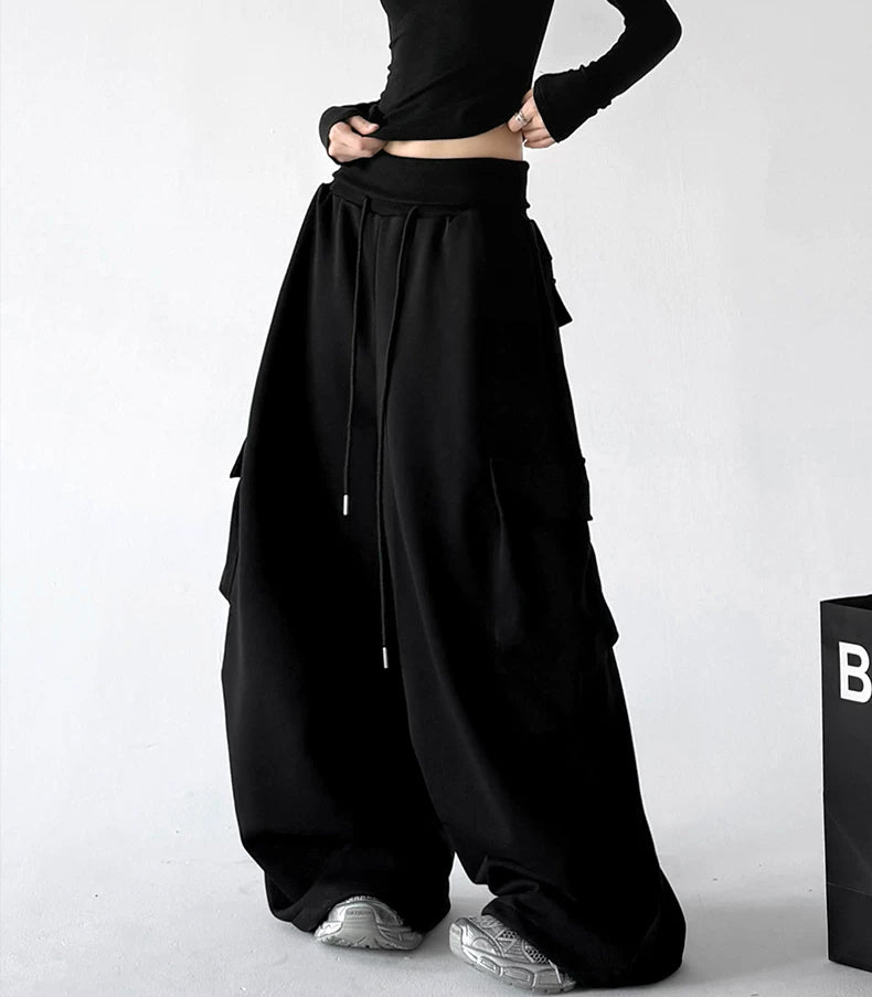 Black wide leg pants, front hands view