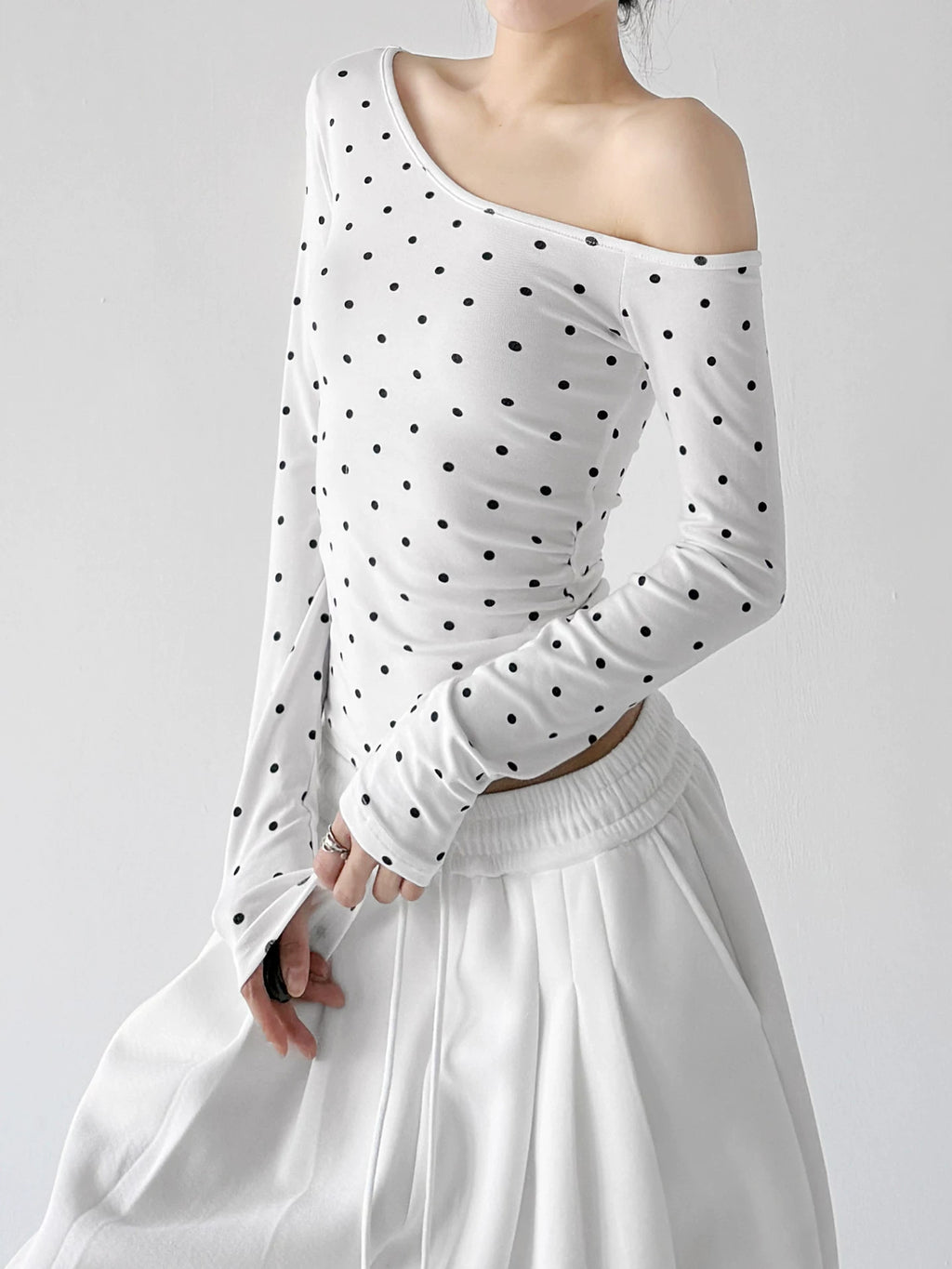 White polka-dot one-shoulder long-sleeve top angled front - CT66322
