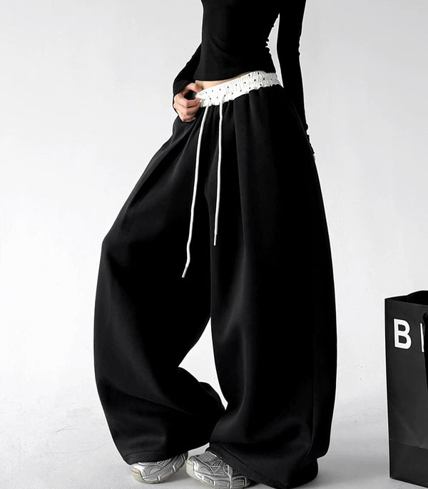 Black contrast waist wide leg pants, angled front view