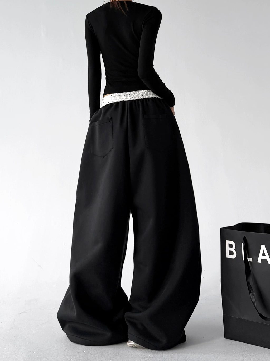 Black contrast waist wide leg pants, back view