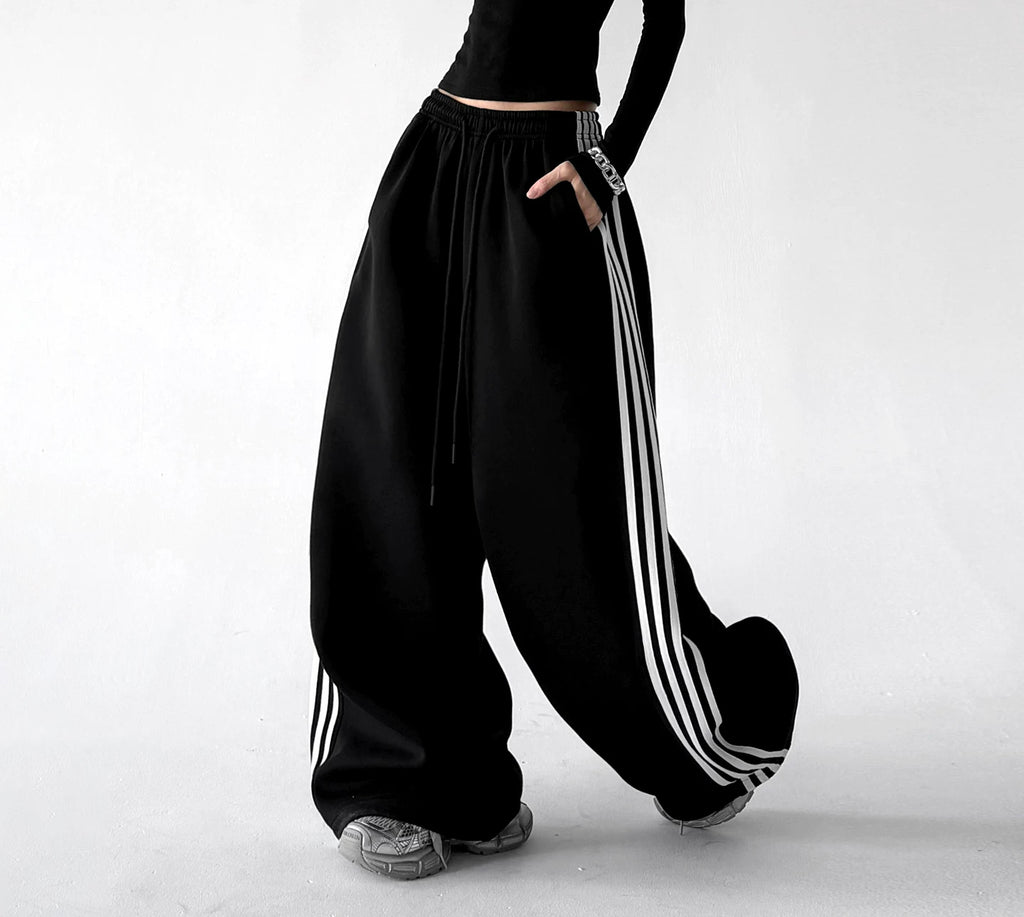 Black wide leg pants, side step view