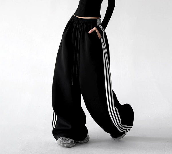 Black wide leg pants, side step view