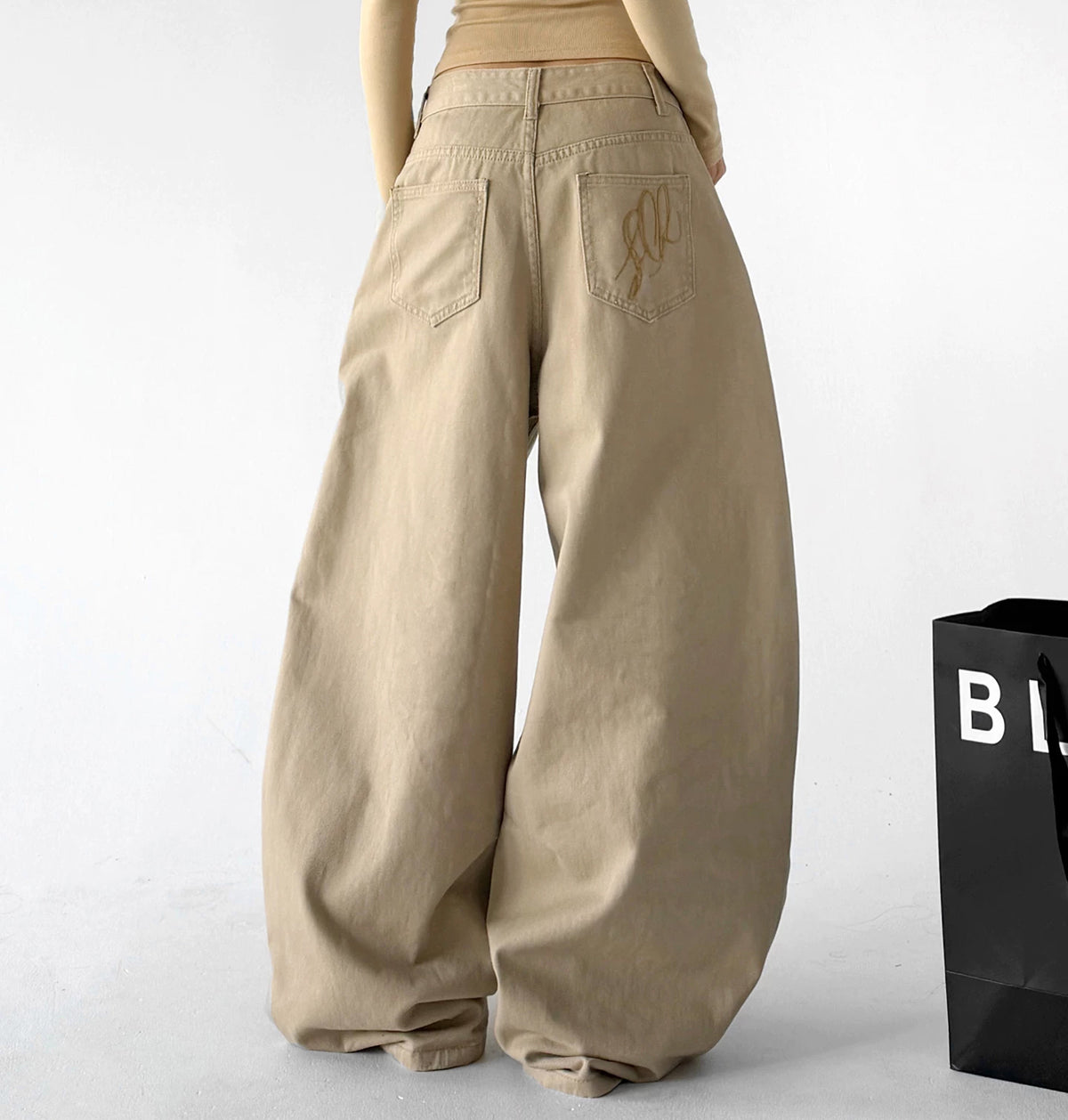 Khaki wide-leg pants, back view.