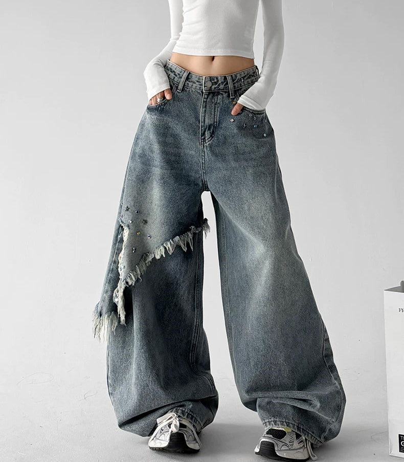Blue fringe baggy jeans, front hands view