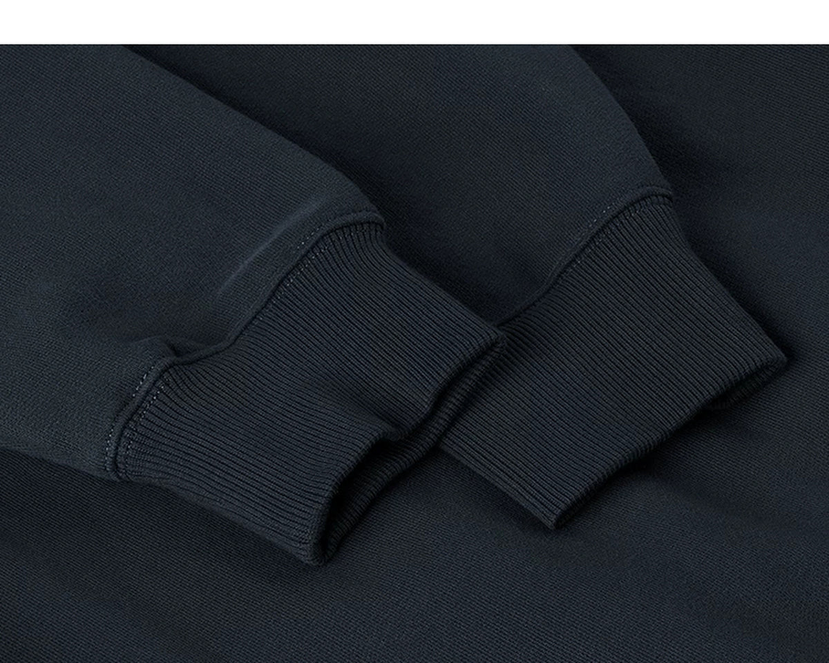 IDLT sweatshirt, navy ribbed cuffs.