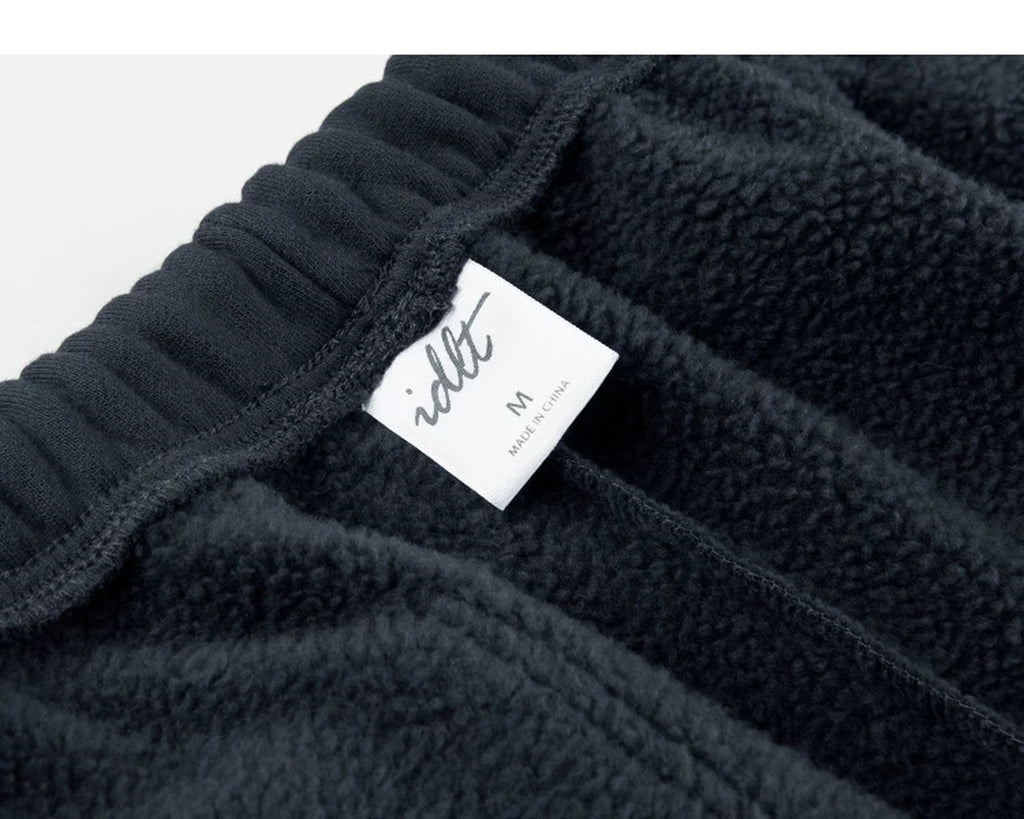 IDLT joggers, navy inner waistband label.