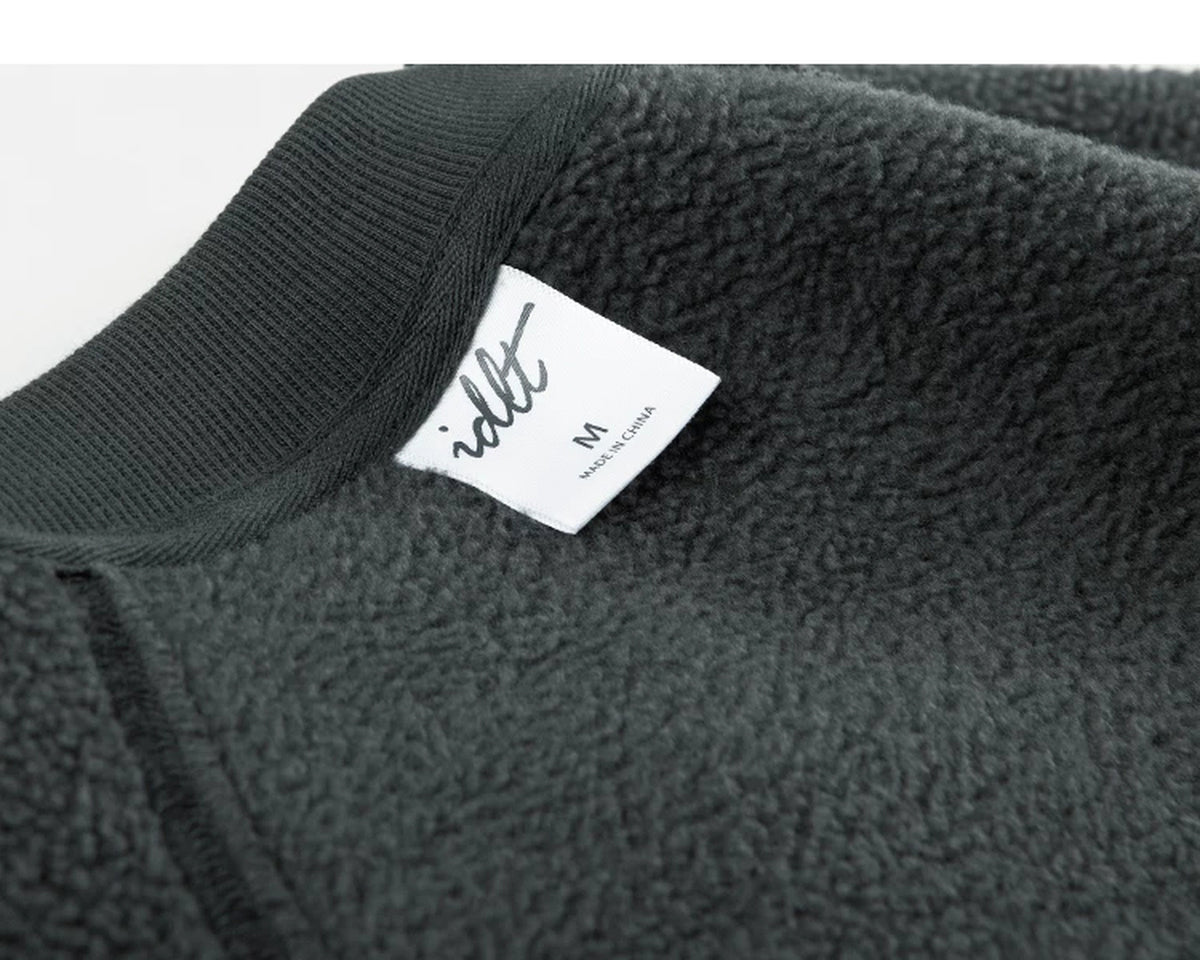 IDLT sweatshirt, dark green inner label close-up.