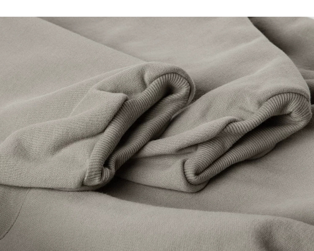 IDLT hoodie, beige ribbed cuffs.