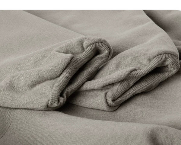 IDLT hoodie, beige ribbed cuffs.