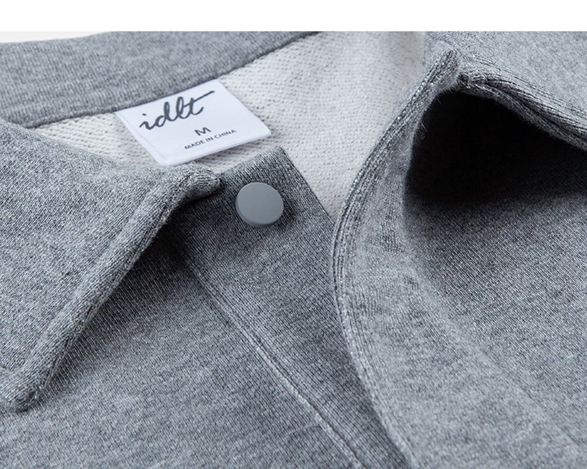 IDLT polo sweatshirt, heather gray open collar and snap fastener.