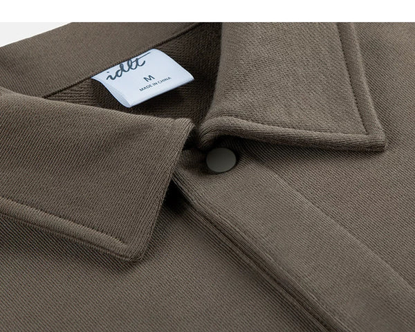 IDLT polo sweatshirt, brown collar and snap button.