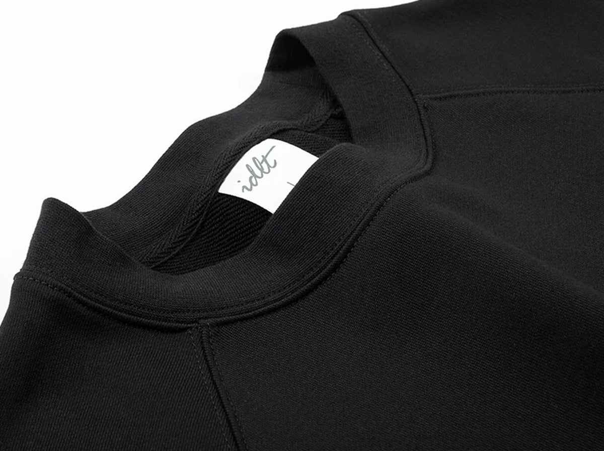 IDLT raglan sweatshirt, black neckline and label.