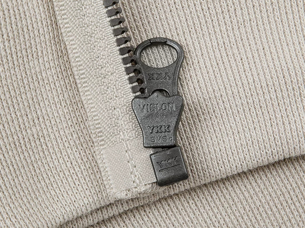 IDLT zip hoodie, cream zipper pull.