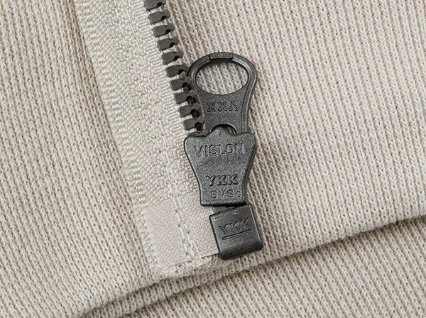 IDLT zip hoodie, cream zipper pull.