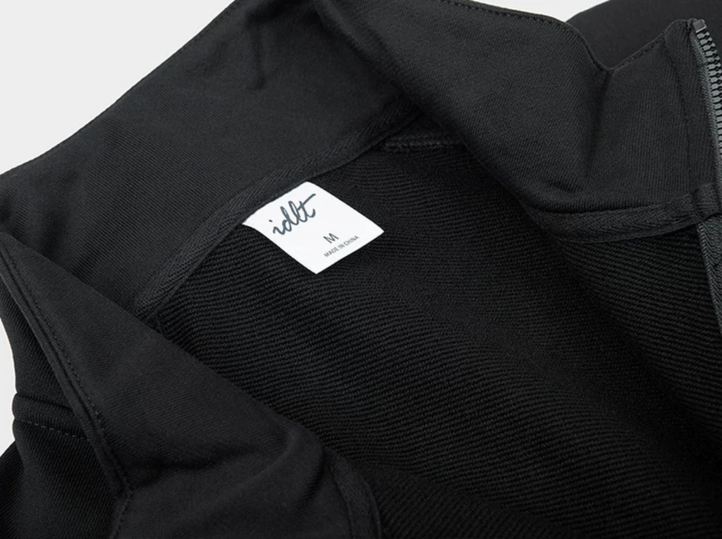 IDLT half zip sweatshirt, black inner neckline label.