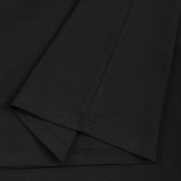 IDLT mock neck top, black folded hem close-up.