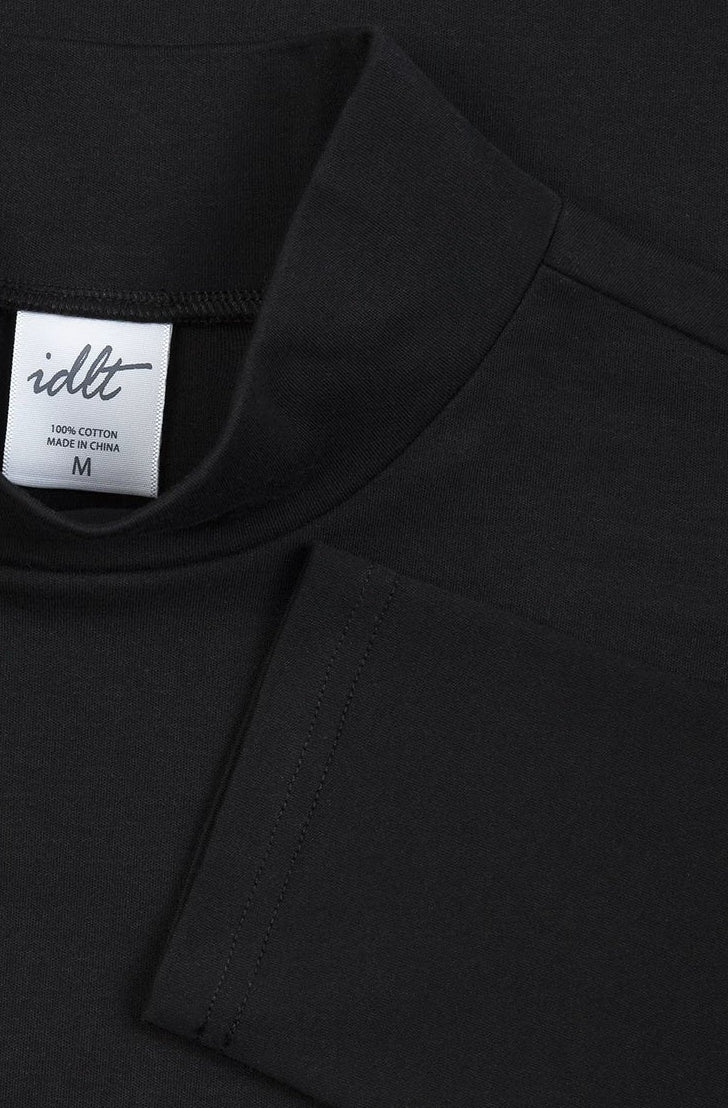 IDLT mock neck top, black collar and label.