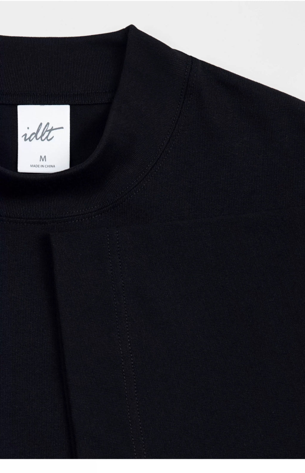 IDLT T-shirt, black neckline and label.