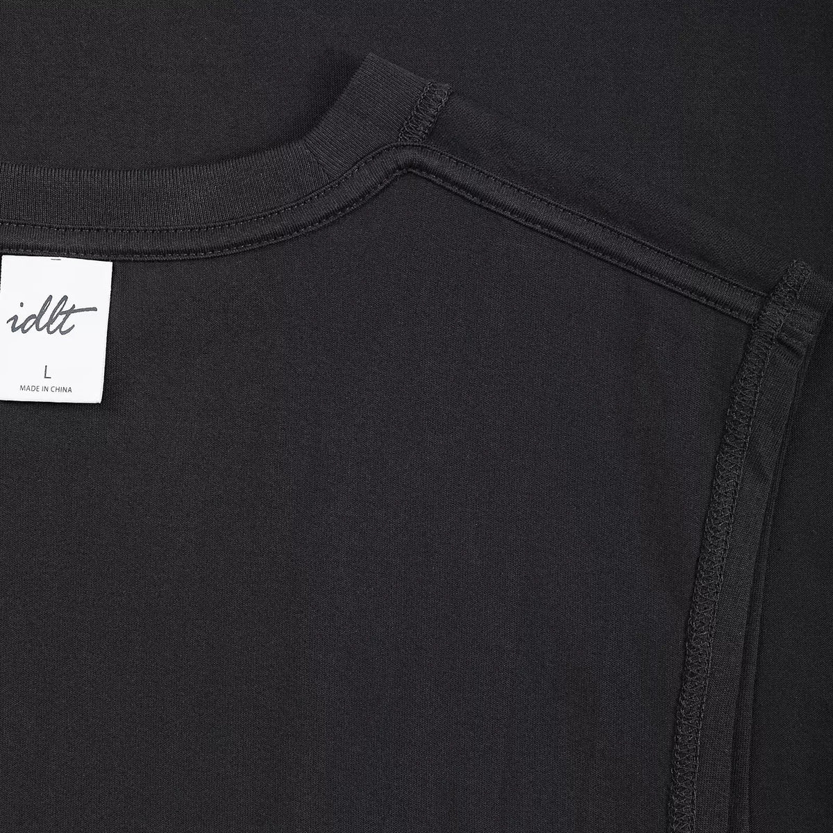 IDLT sleeveless T-shirt, black inner neckline and label close-up.