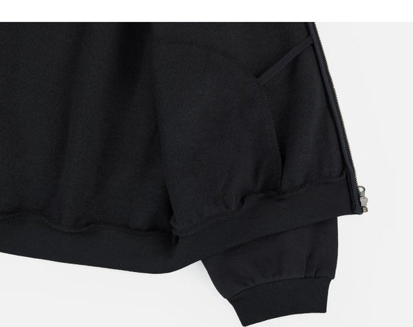 IDLT zip hoodie, black inner hem construction.
