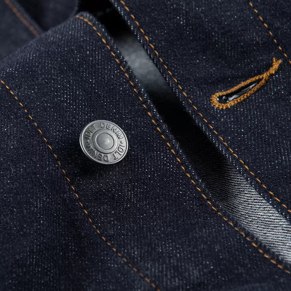 IDLT denim jacket, dark blue button close-up.
