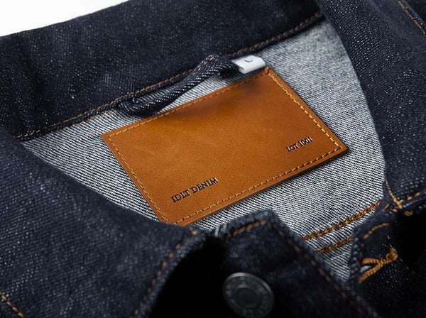 IDLT denim jacket, dark blue inner label patch.