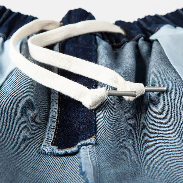 IDLT drawstring jeans, dark blue drawstring tips close-up.