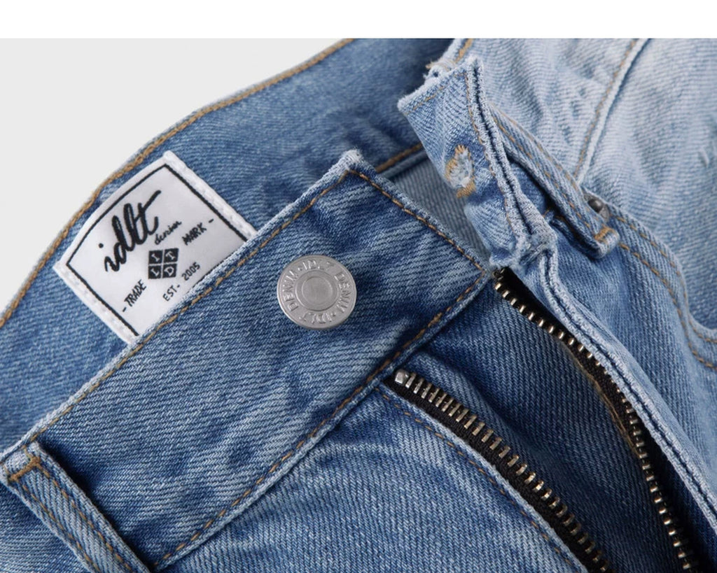 IDLT jeans, light blue waist button and label.