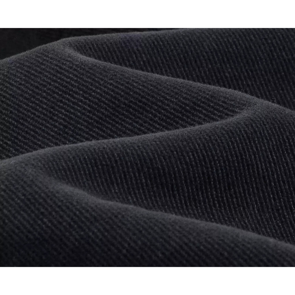 IDLT jeans, washed black denim texture.