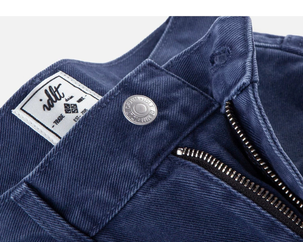 IDLT jeans, blue waist button and label.