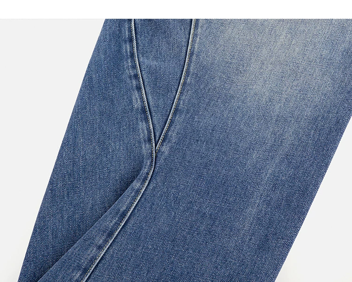 IDLT jeans, washed blue curved leg seam.