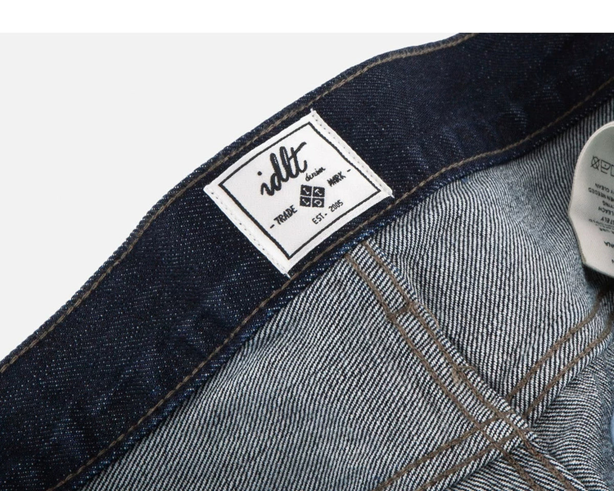 IDLT jeans, dark blue inner label.