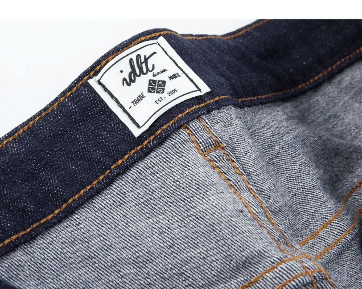 IDLT jeans, dark blue inner label.