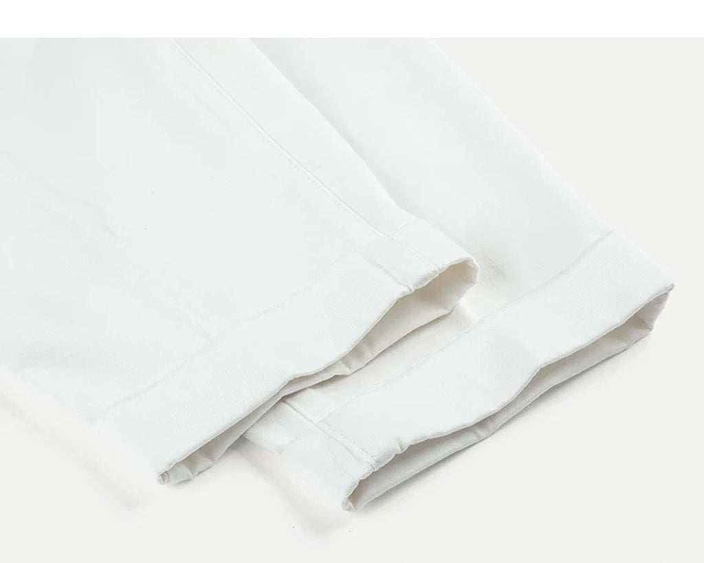IDLT pleated trousers, white leg hems.