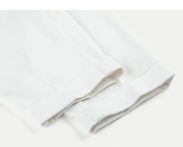 IDLT pleated trousers, white leg hems.