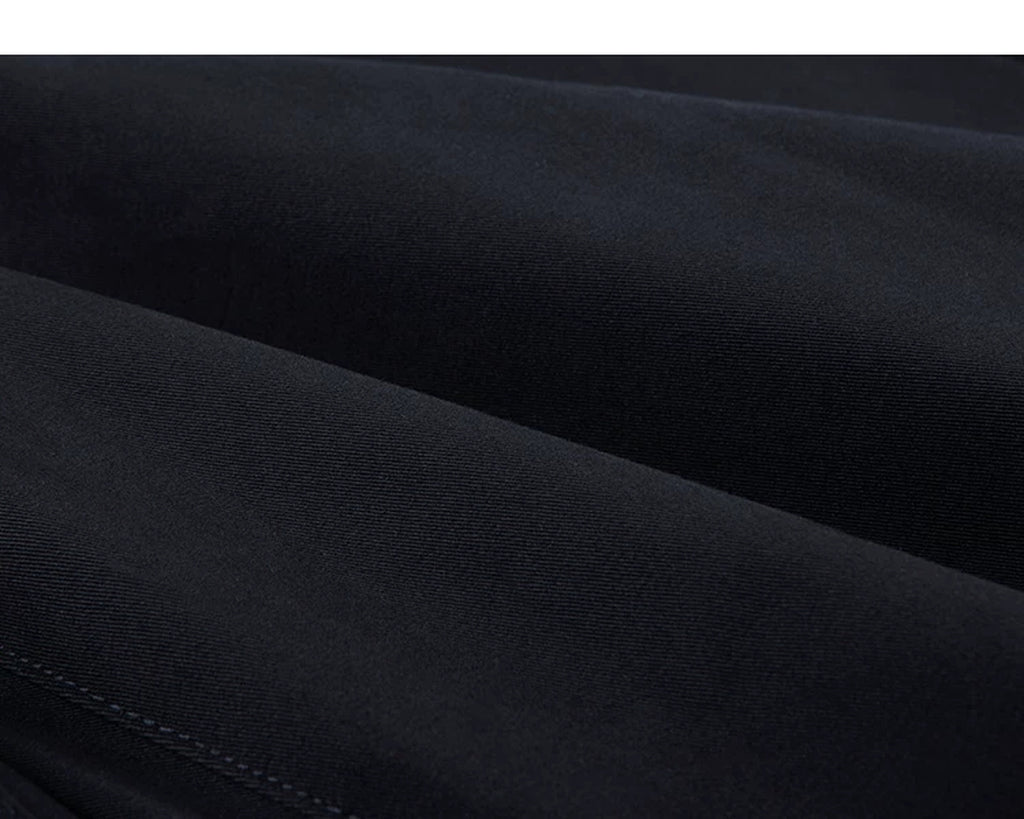 IDLT pleated trousers, navy fabric folds.