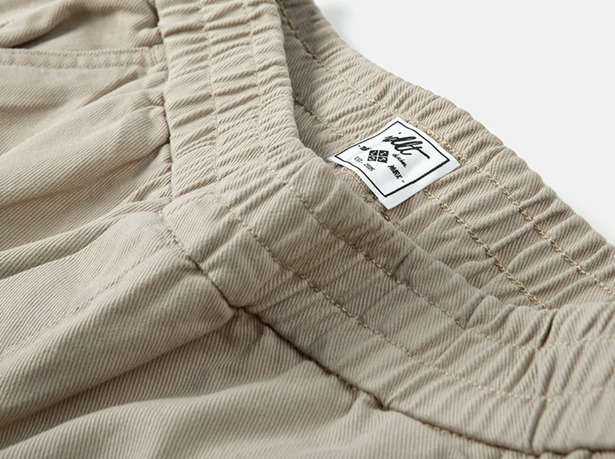 IDLT elastic waist trousers, beige waistband label.