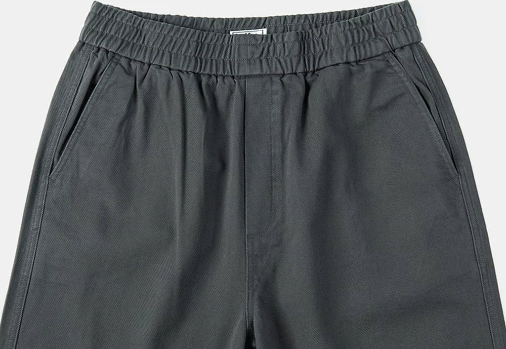 IDLT elastic waist trousers, dark gray waistband and pockets.